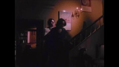 CIRCA 1977 - In this horror film, parents listen in fear from downstairs as a priest performs an exorcism on their daughter.