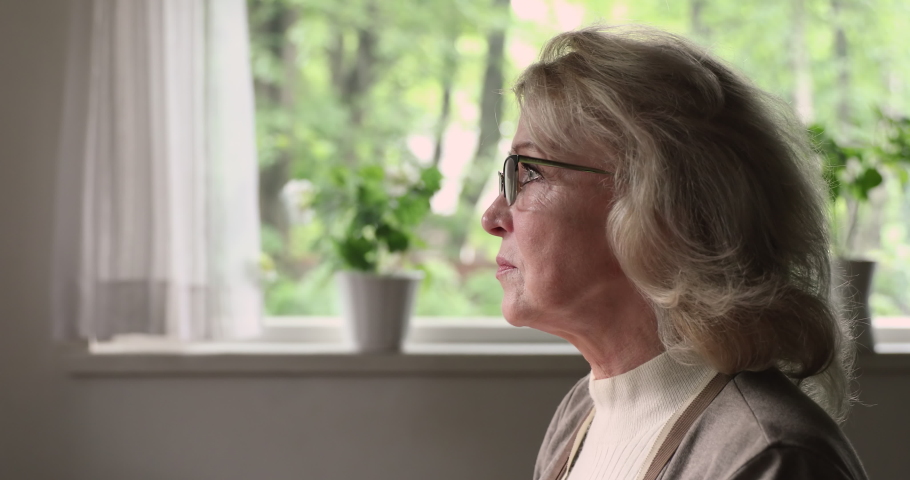 Profile face view aged pensive blond woman in glasses thinking looks into distance touch chin lost deeply in thoughts, contemplating over life troubles, feels lonely. Divorce, personal worries concept Royalty-Free Stock Footage #1060929475