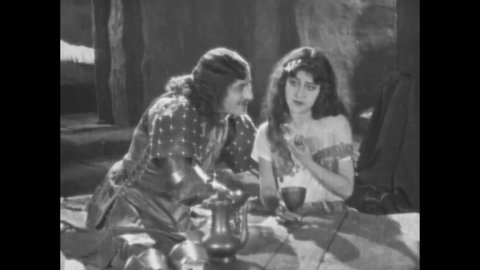 CIRCA 1923 - In this silent movie adaptation of the Hunchback of Notre Dame, Phoebus woos Esmeralda in the moonlight.
