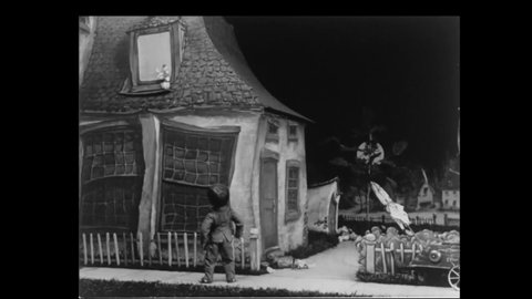 CIRCA 1930 - In this stop-motion animated film, a boy breaks a girl's window trying to get her attention, and uproots a fence she can use as a ladder.