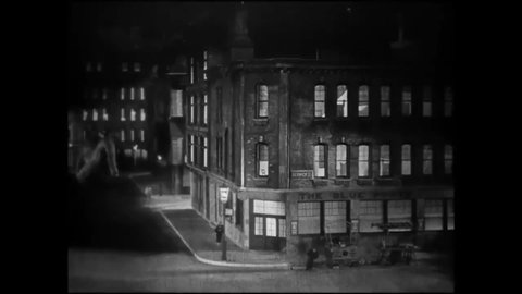 CIRCA 1925 - In this silent adventure movie, a brontosaurus destroys city buildings.
