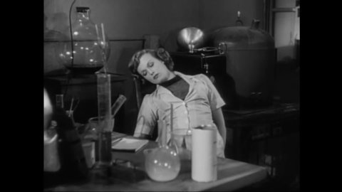 CIRCA 1953 - In this sci-fi film, an invisible alien locks himself in a scientific lab with a female scientist.