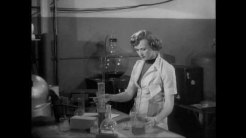 CIRCA 1953 - In this sci-fi film, a scientist tries to help a partially-invisible alien who is struggling to breathe in her lab.