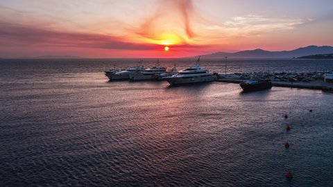 Mykonos, Greece - circa 2019, amazing sunset in harbor, luxury yachts, wonderful sunset, dream shot