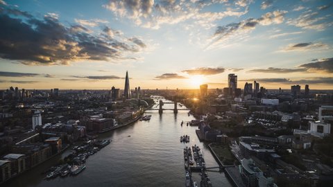 Establishing Aerial View Shot of London UK, Majestic Tower Bridge, calm sunset perfect weather, United Kingdom