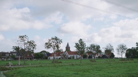 view on a typical Dutch village tilt down from clouds