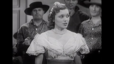 CIRCA 1937 - In this western film, Gene Autry admires a woman singing "Drink Old England Dry" in a saloon with other patrons.