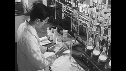CIRCA 1945 - A chemist is seen at work in the toxicology department of a US Army service command laboratory.