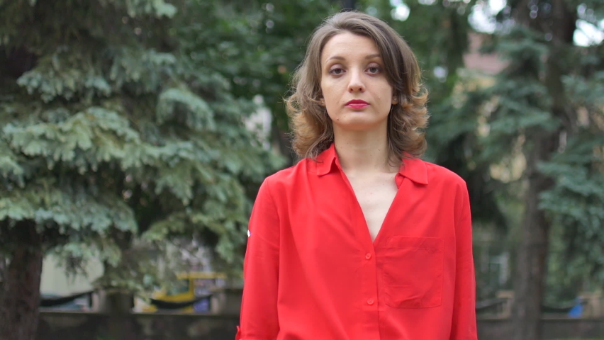 Portrait of young jobless Caucasian woman outdoor with carton poster Need Work. Unemployment after pandemic lockdown.