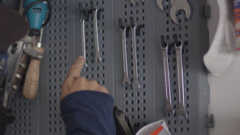 Man chooses a tool from his laboratory, bricolage and "do it yourself" concept