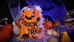 Halloween bag full of candies and sweets. Trick or treat, Halloween spooky scenery with pumpkins, misty fog, candies, skull, spiders and bats.  - Powered by Shutterstock - Get 15% off with code: PIKWIZARD15