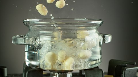 Super Slow Motion Shot of Fresh Gnocchi Falling into Boiling Salted Water at 1000 fps.