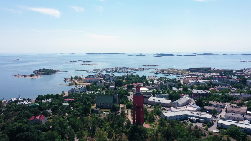 Aerial view overlooking the downtown the church and the water tower, the East harbor in the background, bright, summer day in Hanko, Uusimaa, Finland - dolly, drone shot