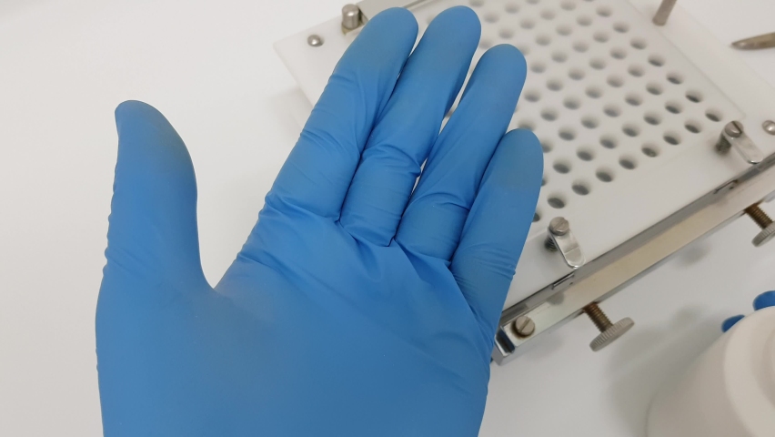 Pharmacist take an hand of pills capsules from bottle for research. Close up