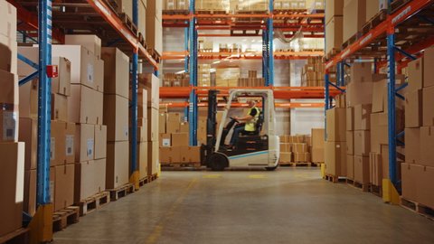 In Big Retail Warehouse Moving Sunlight Illuminates Shelves with Cardboard Boxes. Forklift Driving in Logistics, Distribution Center with Products Ready for Global Shipment, Customer Delivery