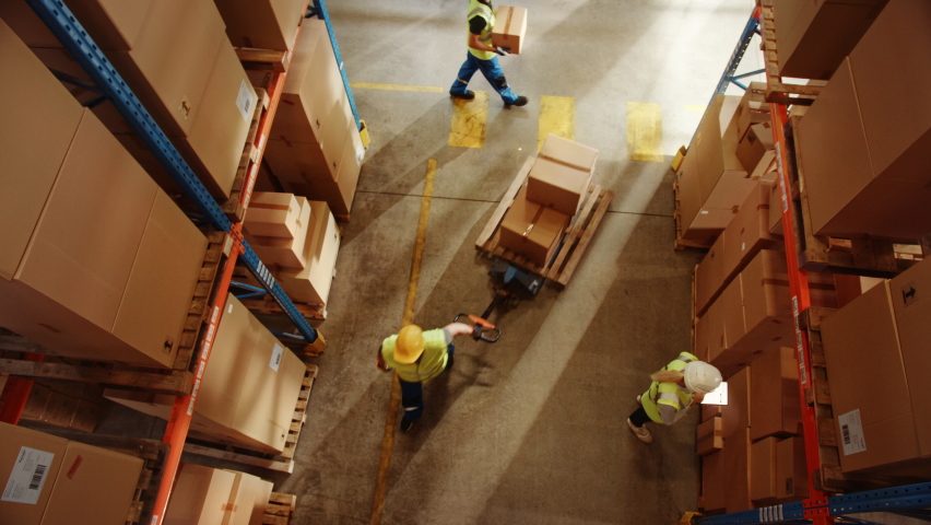 Top-Down Elevating View: Worker Moves Cardboard Boxes using Manual Pallet Truck, Walking between Rows of Shelves with Goods in Retail Warehouse. People Work in Product Distribution Logistics Center | Shutterstock HD Video #1060977124