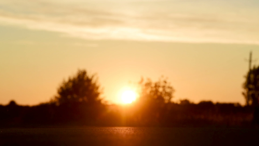 The movement of the car on the road at sunset. Slow motion
