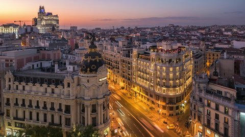 Time lapse view of sunset over historic buildings and traffic on Gran Via street in Madrid, the capital and largest city in Spain.