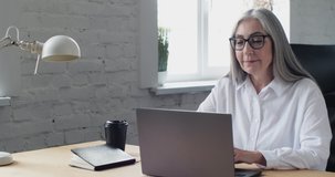Old middle-aged mature Woman holding Video-Call, Online Conversation, Seminar. Happy senior Businesswoman talking with Family, Friends on Skype. Progressive Life, World, People. Easy Technology.