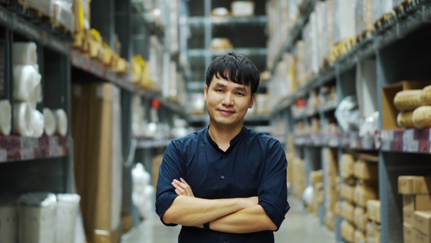 Male manager with arms crossed in the warehouse store | Shutterstock HD Video #1060982728