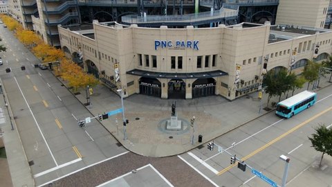 Pittsburgh , PA / United States - 10 10 2020: Aerial tilt up reveals front entrance of PNC Park, home of Pittsburgh Pirates MLB major league baseball team, yellow autumn foliage