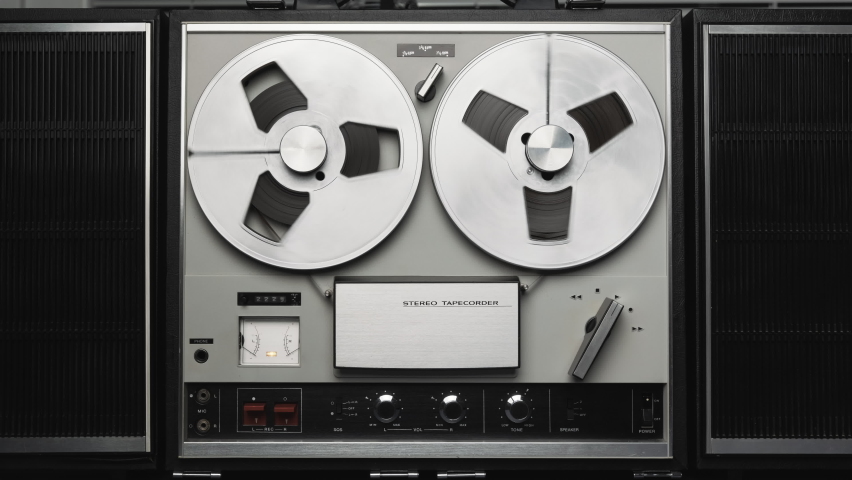 Reel to reel tape recorder playing. Rotating vintage music player close up. Retro tape. Spinning reels metallic color. Party. Loop. Front view. Front view. Popular Disco Trends 60s, 70s, 80s, 90 Royalty-Free Stock Footage #1060987075