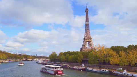 4k vedio of the amazing view of the Eiffel tower from Bir-Hakeim bridge, over the river Seine , Paris, France. Paddle steamer on river at a cloudy but sunny autumn day.