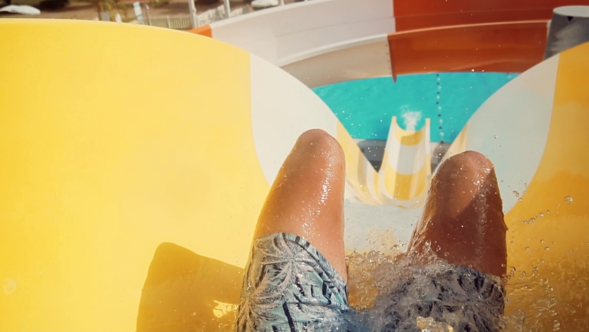 Funny Ride On Water Slide Pool In Water Park. Sliding Down In Waterpark. Man Having Fun On Water Slides Aqua Park Glides. Happy Cheerful Male On Holiday Resort. Summer Vacation Enjoying On Waterslide Royalty-Free Stock Footage #1060990819