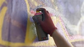 Street Graffiti Art Spray Paint Close Up. Young man doing some spray painting on a wall in the street. Graffiti art - Powered by Shutterstock - Get 15% off with code: PIKWIZARD15