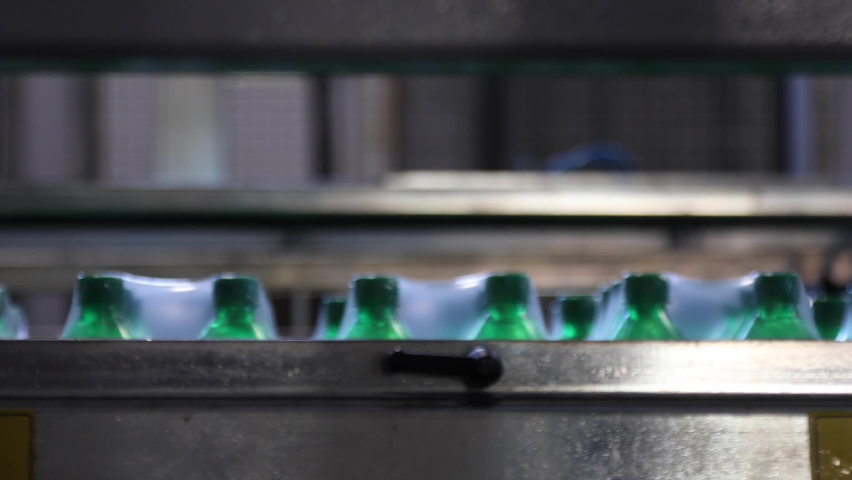 Packaging of ready to sell plastic mineral water bottles at the beverage factory
