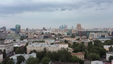 Buildings in the centre of Moscow landscape, fly over drone shot. Many diverse factory and residential buildings top view shot in Moscow during a grey autumn day.