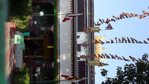 Varanasi, Uttar Pradesh/India- September 20 2020 : Footage of the exterior of a Tibetan temple in Sainath area in Varanasi, India. Tibetan flags are being hoisted in the air with selective focus.