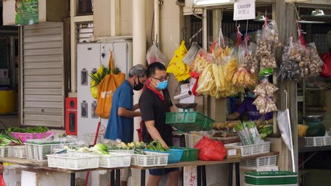 Singapore / Singapore - 10 15 2020: Two men wearing face mask selling fruits at stall, Toa Payoh 