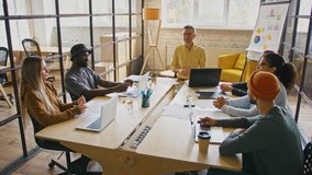 Tracking shot of young coworkers with team leader discussing after pandemic plan, sitting in cozy office, slow motion - Powered by Shutterstock - Get 15% off with code: PIKWIZARD15