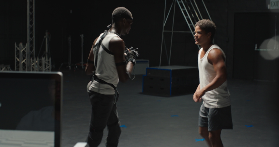 martial artist wearing motion capture suit in studio performing martial arts fighting wearing mo-cap suit for 3d character animation for augmented reality technology