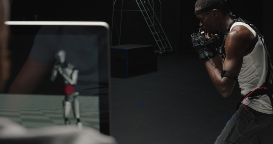 fit man wearing motion capture suit computer game performing martial arts boxing wearing mo-cap suit for 3d character animation for virtual reality fighting