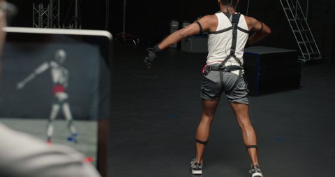 dancing man wearing motion capture suit in studio actor wearing mo-cap suit for 3d character animation for virtual reality technology