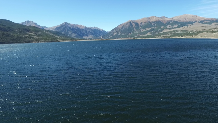 Aerial view of blue lake with massive mountain. Mt Elbert in Rocky mountain. Gliding over crystal clear lake. Colorado Rockies
