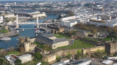 France, Bretagne, Brittany, Brest, close-up of Marine National Museum with Recouvrance bridge and Tanguy tower in the background. Drone aerial view during sunny day.