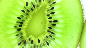 Top view Rotate of Transparent Slice of kiwi fruit  on white background, Close up fresh kiwi sliced on white background and slowly rotating.