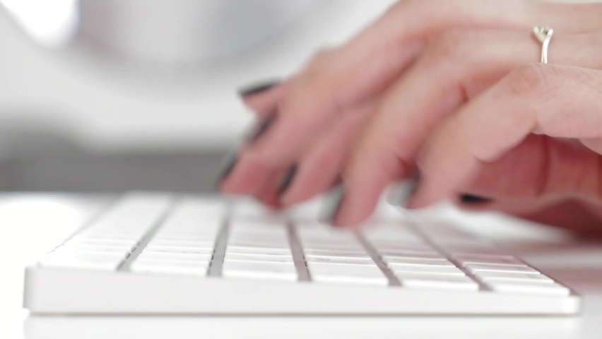 A women is typing on a white keyboard. Computer Keyboard. Royalty-Free Stock Footage #1061035264