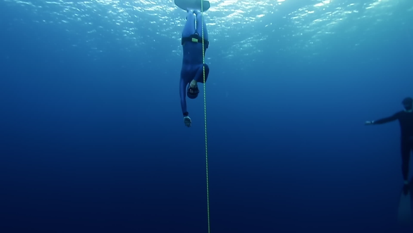 Woman freediver descends into depth along the rope Royalty-Free Stock Footage #1061038168