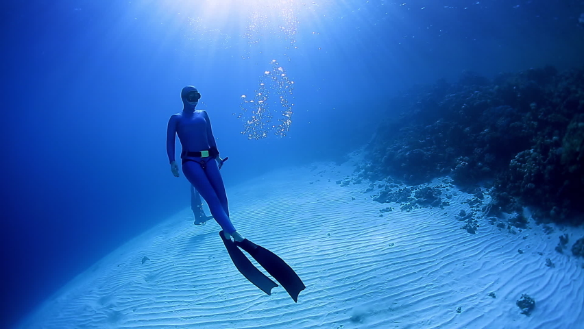 Woman freediver ascends from depth in bifins Royalty-Free Stock Footage #1061038177