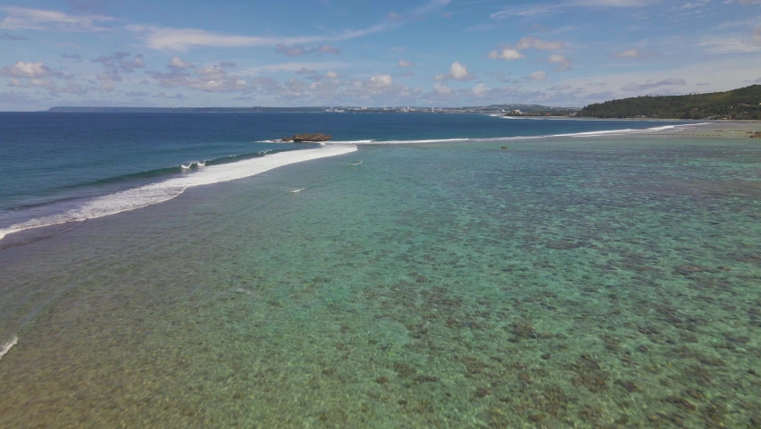Drone shot rising up over the waters of the tropical island Guam`