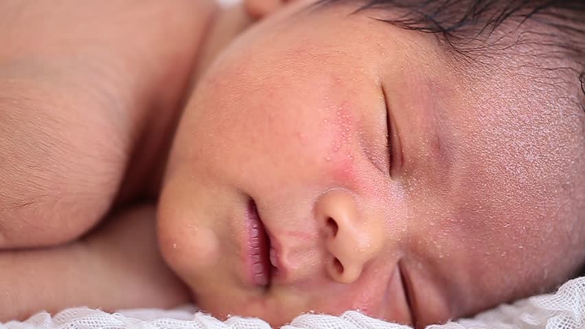 Close-up portrait of a beautiful sleeping baby on suitcase 