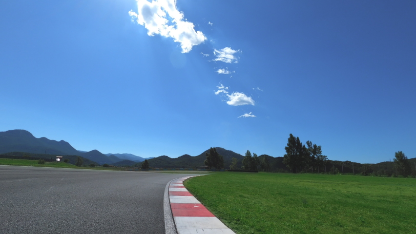 Personal view of motorcycle rider driving on raceway. Feeling of speed and curvy speedway.
