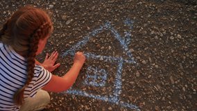 child kid draw a house on the asphalt with chalk . childhood mortgage dream kid concept. little girl playing draws with chalk big house. concept loan mortgage for a dream home residential building - Powered by Shutterstock - Get 15% off with code: PIKWIZARD15