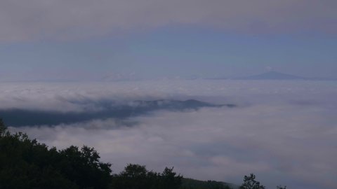 Timelapse of sky and clouds on the mountain. View of the cloudy valley and fog. 4K