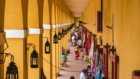 Cartagena, Colombia - December 09: Zoom out time lapse view of tourists at historical landmark Las Bovedas Market in the Old City of Cartagena in Colombia.