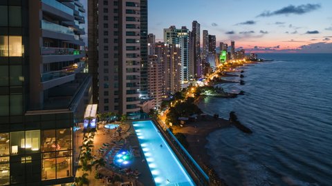 Cartagena de Indias, Colombia, zoom out time lapse view of high rise buildings and beaches in the Bocagrande neighbourhood at sunset. 